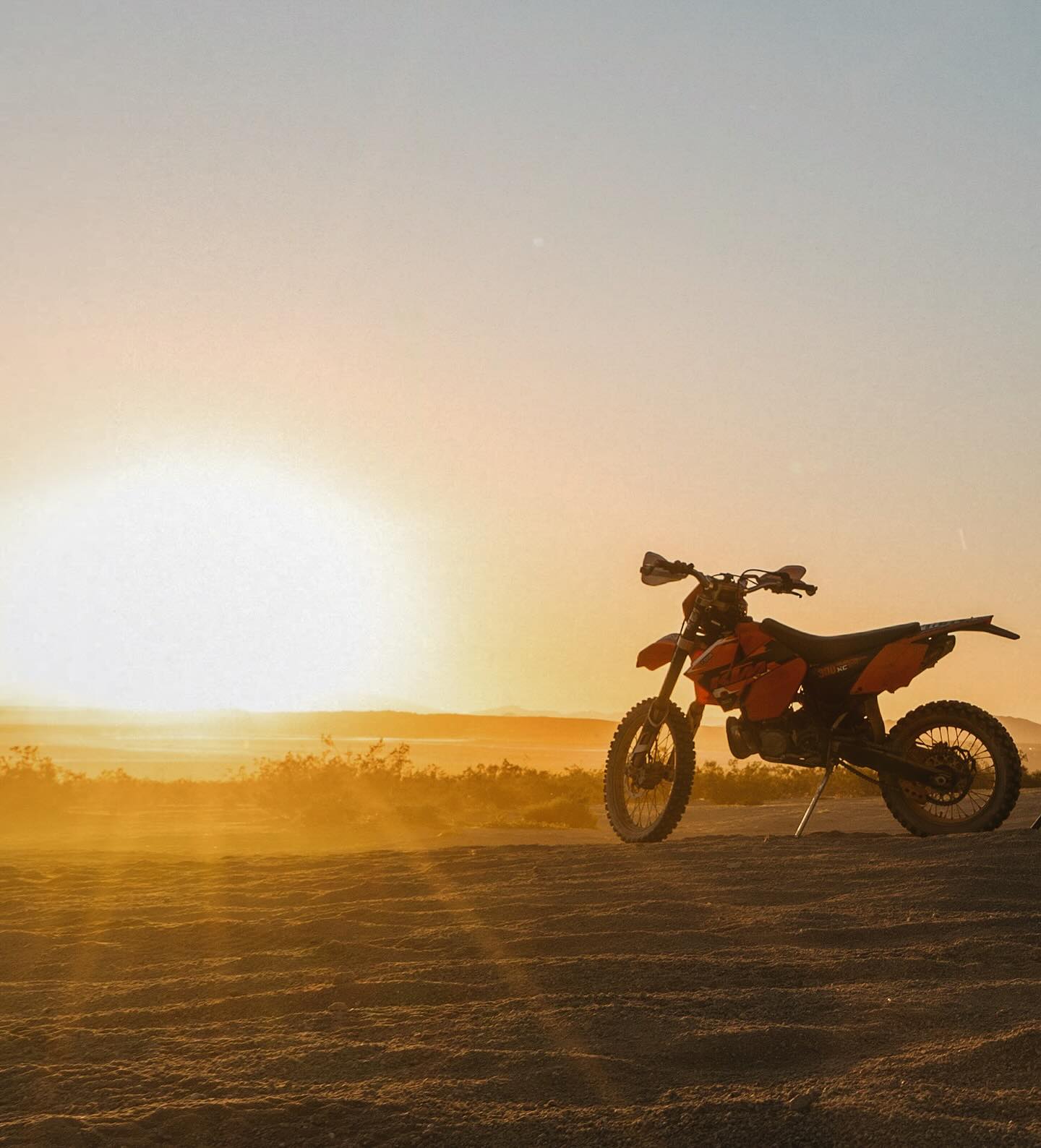 Motorcycle at sunset beside camp