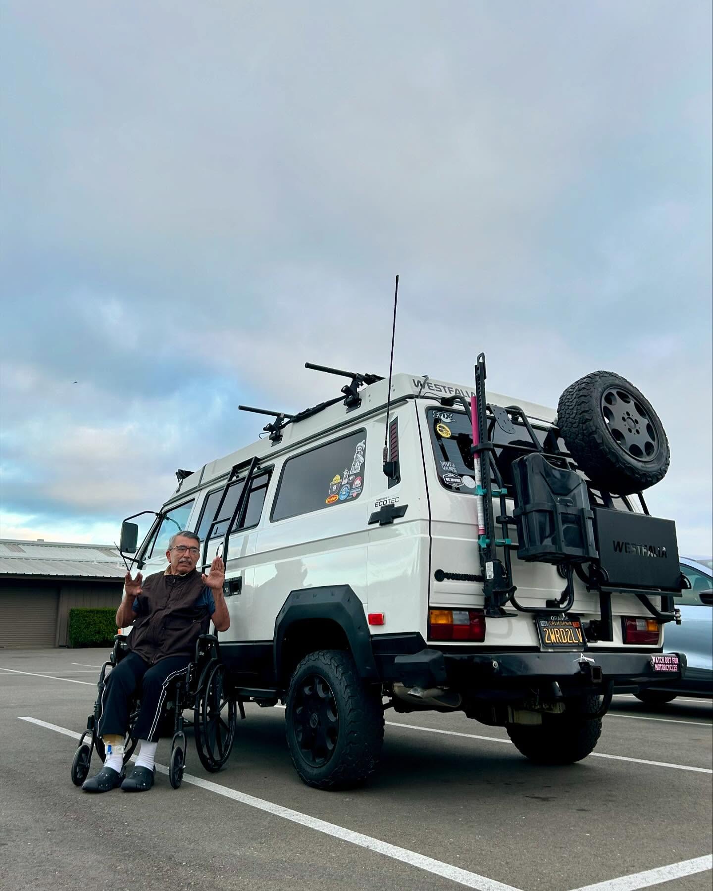 Westfalia with bike rack parked under cloudy sky